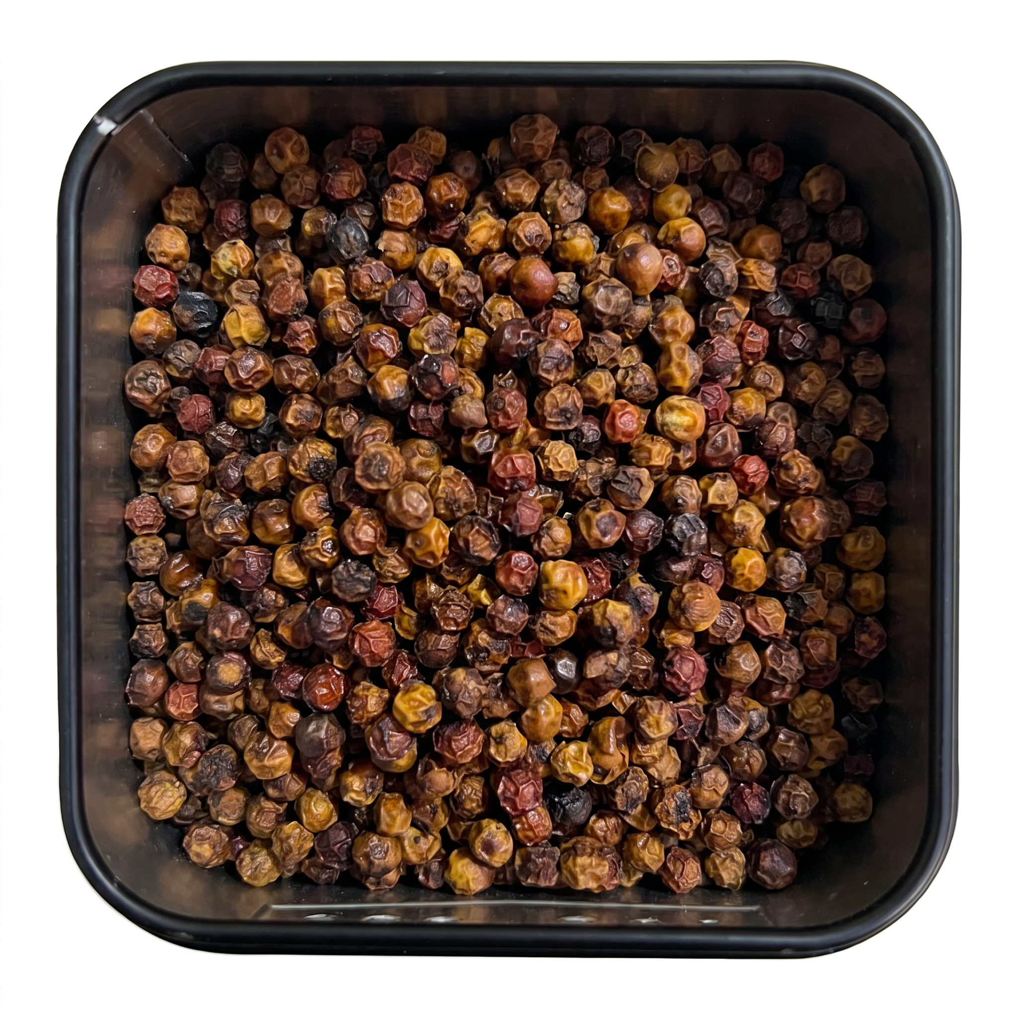 Roter Kampot Pfeffer, ganze rotbraune bis orangegelbe, teils rote Pfefferkörner, in schwarzer Gewürzdose, würzig-fruchtig.