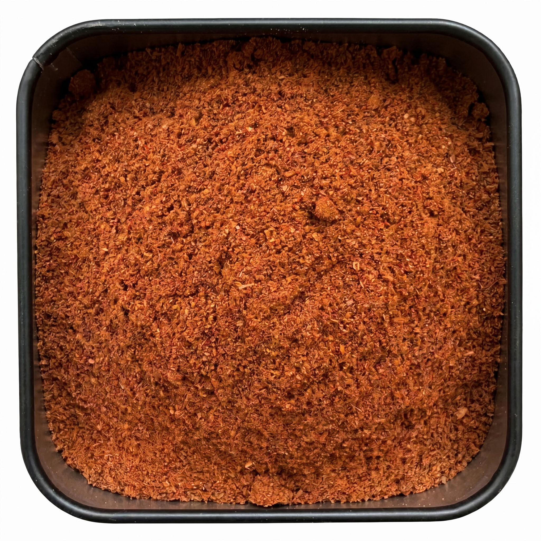 Tandoori Masala, kräftig rot-oranges Gewürzpulver, in schwarzer Gewürzdose, würzig-warmes Aroma.